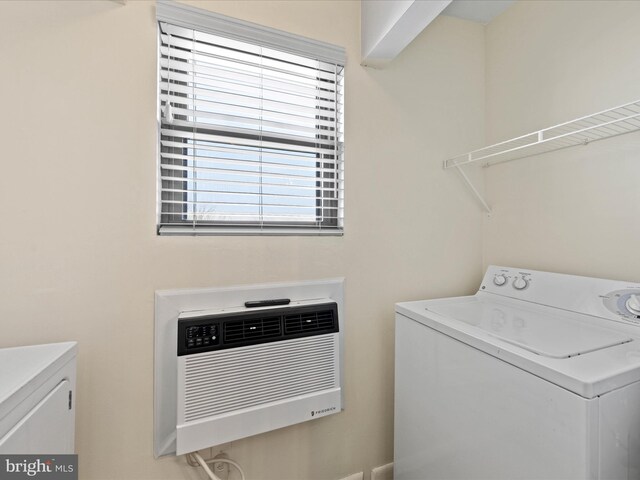 laundry area featuring washing machine and clothes dryer and laundry area