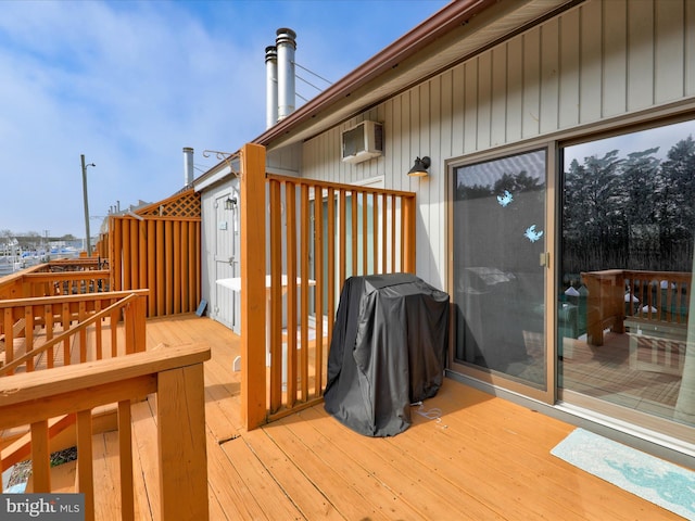 deck featuring a grill and an AC wall unit