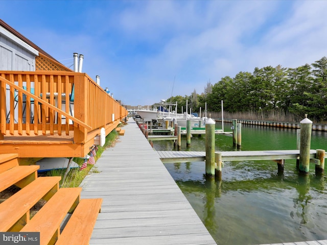 dock area with a water view and boat lift