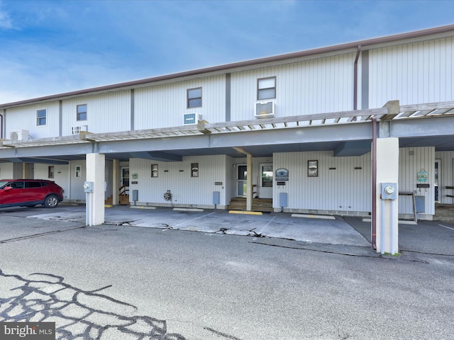 view of front of home featuring cooling unit and covered parking