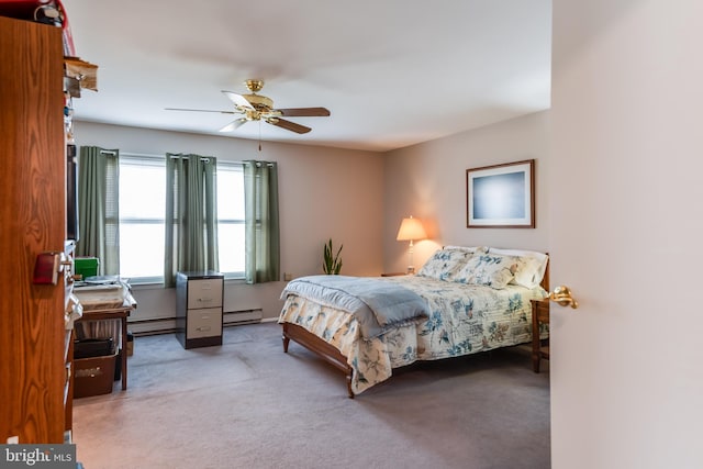 carpeted bedroom featuring a baseboard heating unit, baseboard heating, and a ceiling fan