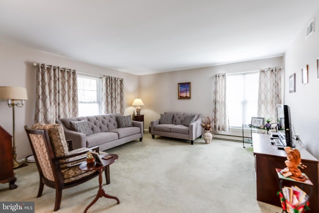 living room with a baseboard heating unit, visible vents, and carpet flooring