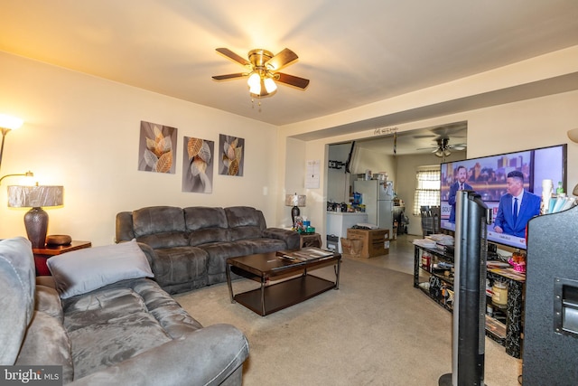 carpeted living room with a ceiling fan