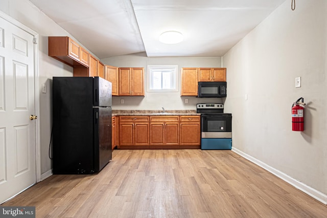 kitchen with light wood finished floors, baseboards, light countertops, brown cabinets, and black appliances