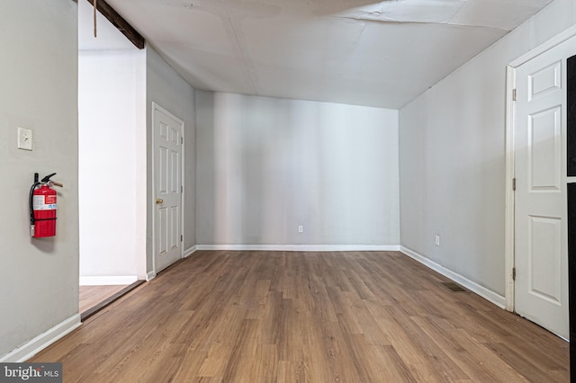 bonus room with visible vents, baseboards, and wood finished floors