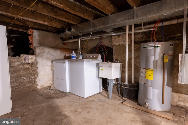 interior space with washer and dryer, electric water heater, and a sink