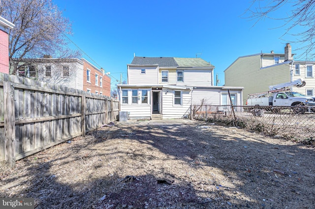 rear view of property featuring fence private yard and entry steps