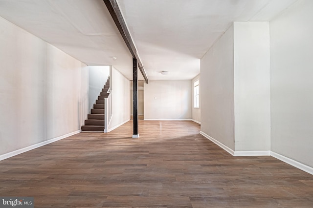 basement featuring stairs, baseboards, and wood finished floors