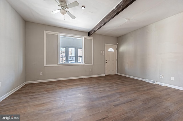 foyer with beam ceiling, wood finished floors, visible vents, and baseboards