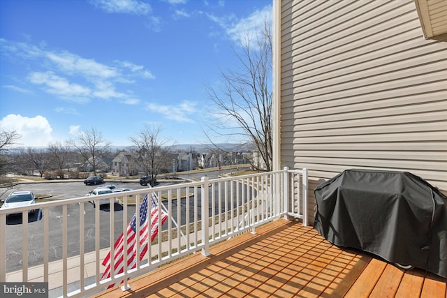 wooden terrace with a residential view and area for grilling