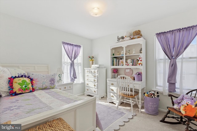 carpeted bedroom featuring baseboards