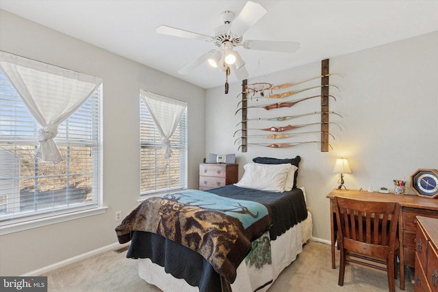 bedroom with light carpet, visible vents, a ceiling fan, and baseboards