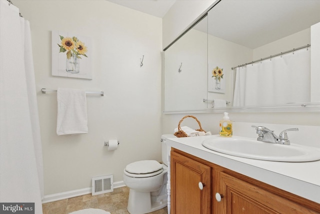 bathroom featuring vanity, toilet, baseboards, and visible vents