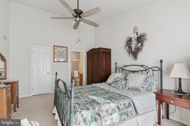 bedroom with visible vents, baseboards, a towering ceiling, and light carpet