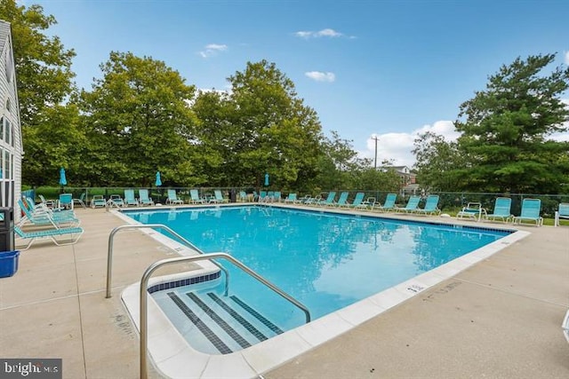 pool featuring a patio area and fence