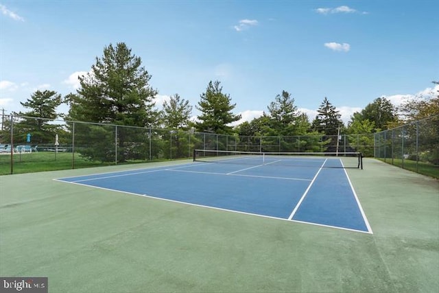 view of sport court featuring fence