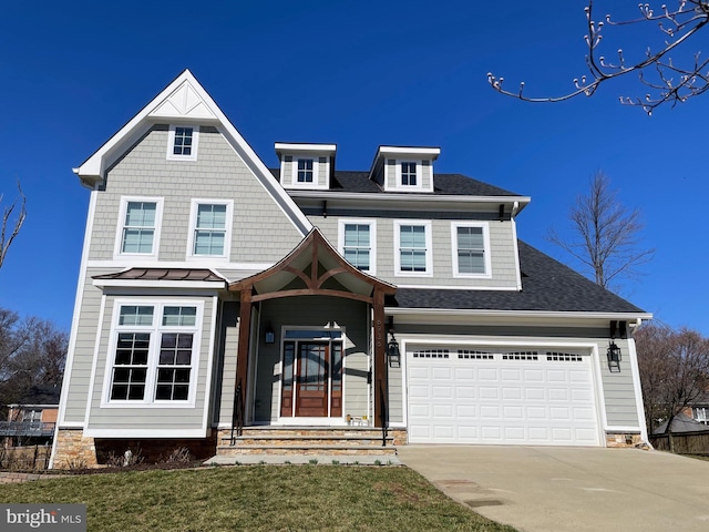 view of front of house featuring concrete driveway, roof with shingles, metal roof, a garage, and a standing seam roof