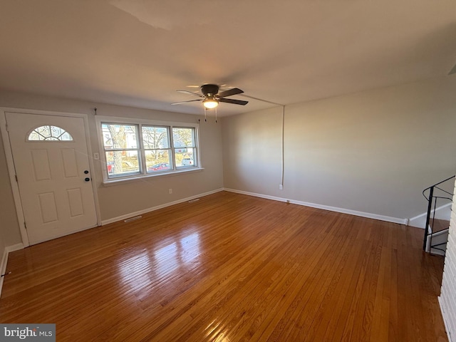 entrance foyer with baseboards, visible vents, ceiling fan, and wood finished floors