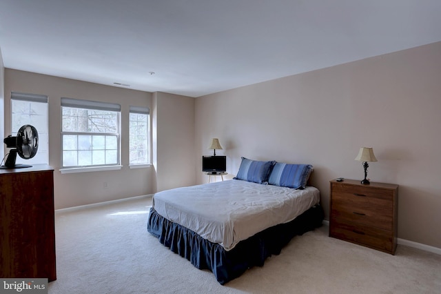 carpeted bedroom with visible vents and baseboards