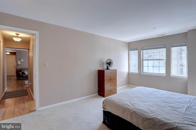 carpeted bedroom with visible vents and baseboards