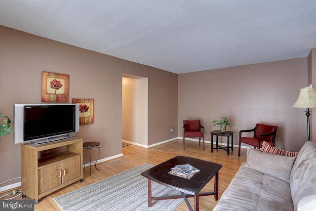 living room featuring baseboards and light wood-style flooring