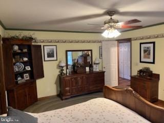 bedroom with ceiling fan and crown molding