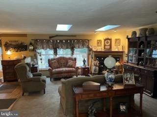 carpeted living area with a skylight