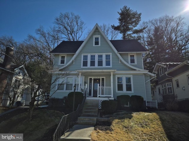 view of front facade featuring covered porch and stairs