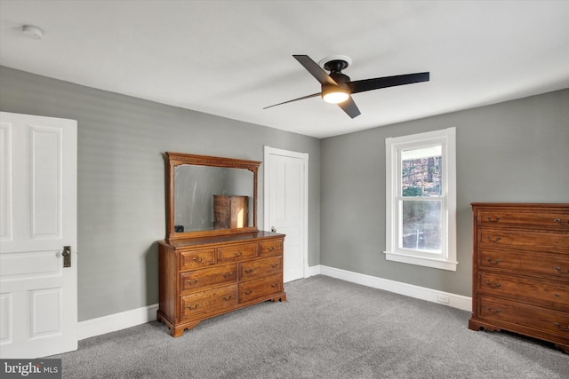 carpeted bedroom with baseboards, a closet, and ceiling fan