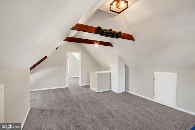 additional living space featuring baseboards, lofted ceiling with beams, and carpet