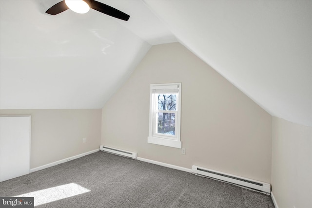 additional living space featuring vaulted ceiling, carpet, baseboards, and a baseboard radiator