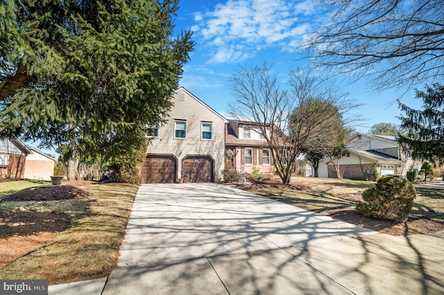 view of front facade featuring concrete driveway and a garage