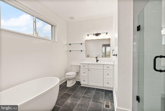 full bathroom featuring visible vents, a freestanding bath, a stall shower, and vanity