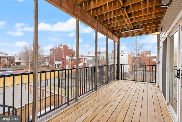 unfurnished sunroom with a residential view and a wealth of natural light