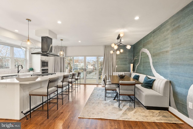 living room featuring recessed lighting, light wood-style floors, and a chandelier