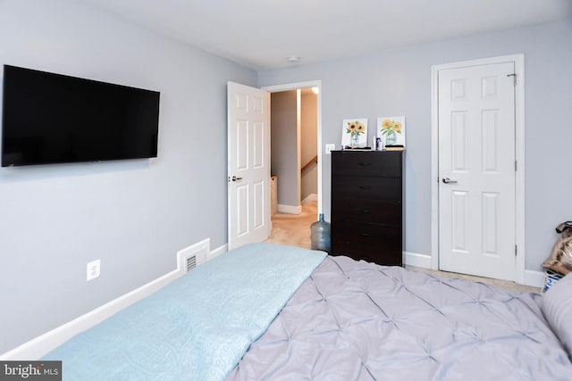 bedroom with baseboards and visible vents