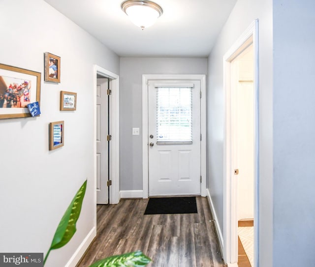 entryway featuring baseboards and dark wood finished floors