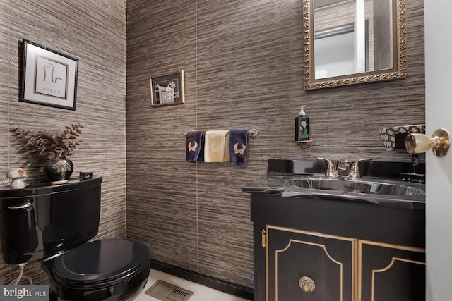 bathroom featuring visible vents, toilet, and vanity