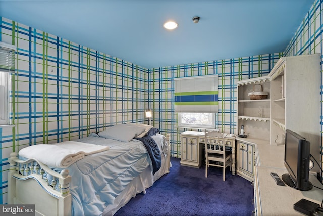 bedroom featuring dark colored carpet, tile walls, and wallpapered walls