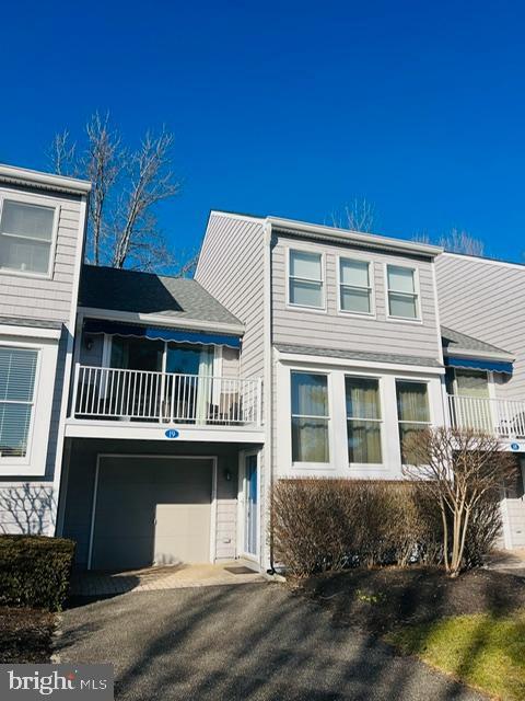 view of front of property with a balcony and an attached garage