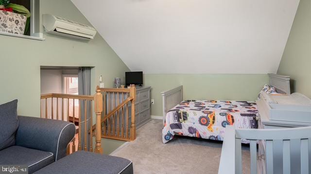 bedroom with lofted ceiling, an AC wall unit, and carpet flooring