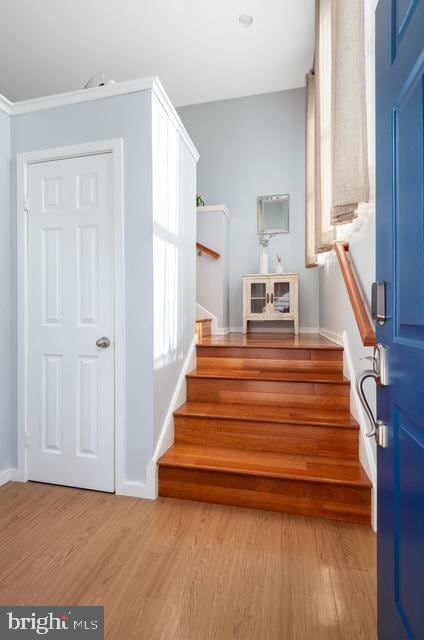 stairs featuring wood finished floors and baseboards