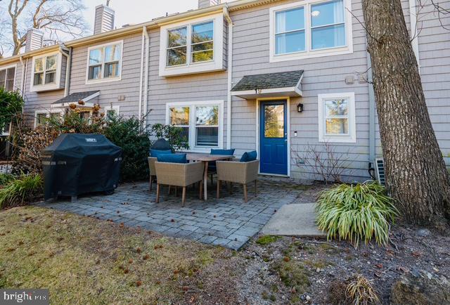 rear view of property with a patio and a chimney