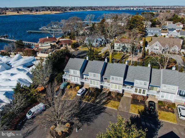 birds eye view of property featuring a water view and a residential view