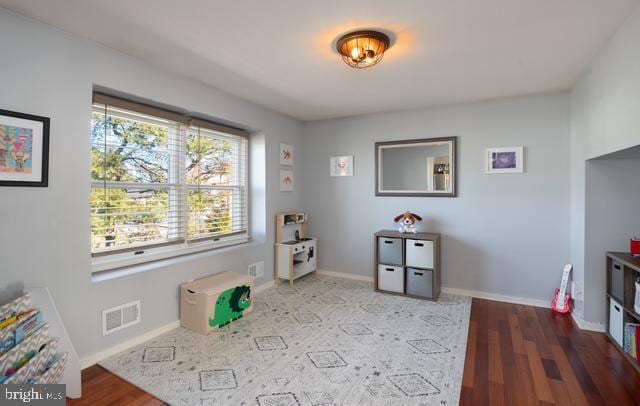 game room featuring visible vents, baseboards, and wood finished floors