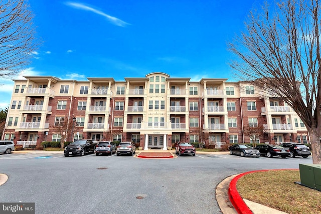 view of property featuring uncovered parking