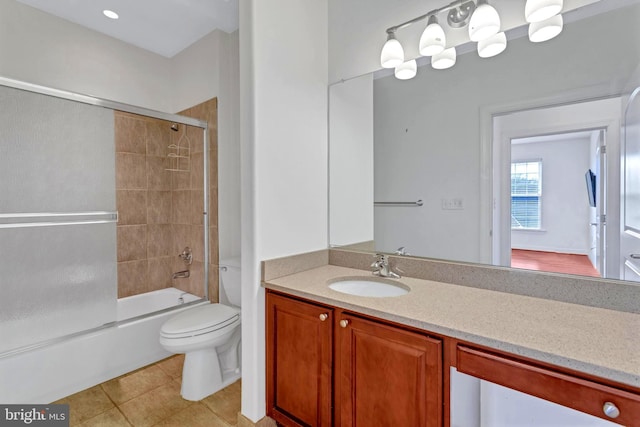 full bath with tile patterned flooring, shower / bath combination with glass door, vanity, and toilet