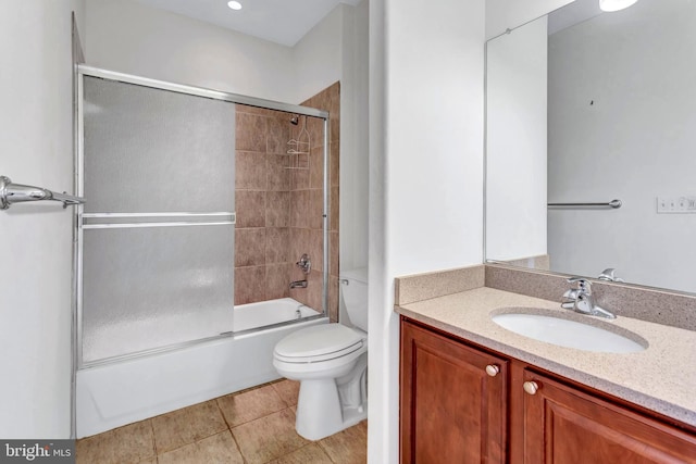 full bathroom featuring shower / bath combination with glass door, vanity, toilet, and tile patterned floors