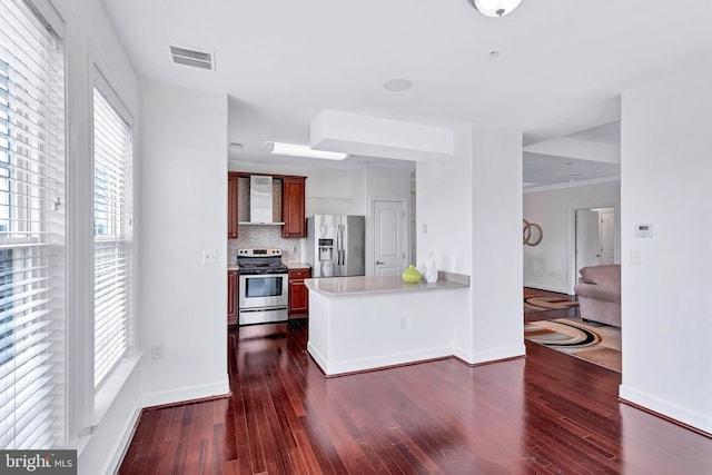 kitchen with light countertops, appliances with stainless steel finishes, dark wood finished floors, and visible vents