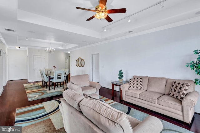 living room featuring crown molding, visible vents, a raised ceiling, and wood finished floors